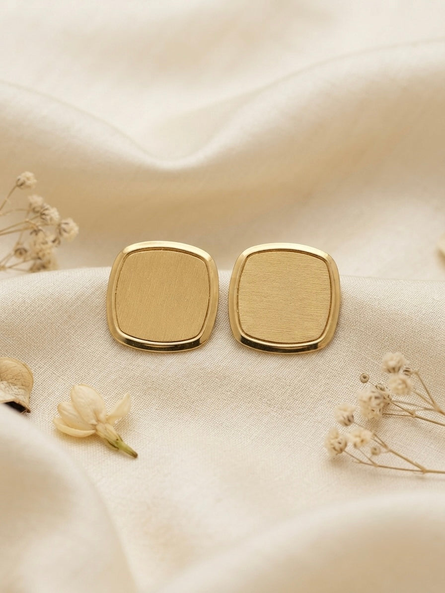 Modern minimalist brushed square studs.