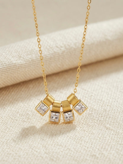 Gold four crystal square charm slider necklace.