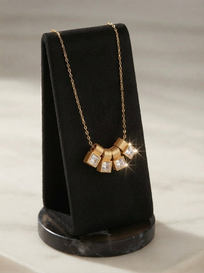Gold four crystal square charm slider necklace.