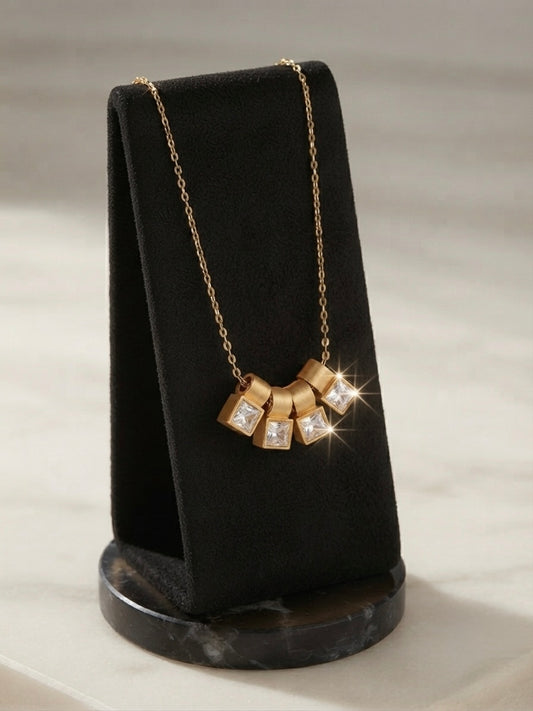 Gold four crystal square charm slider necklace.
