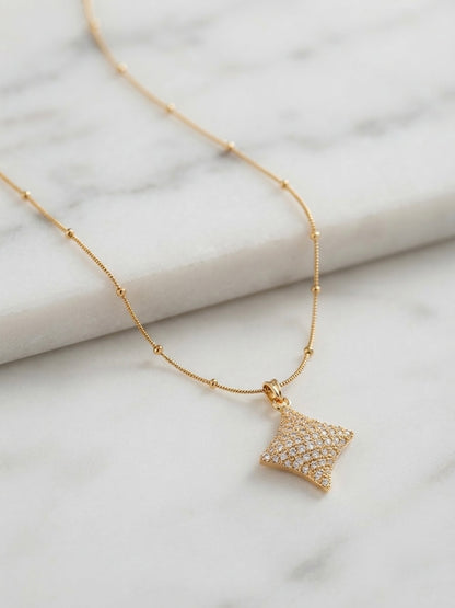 Elegant crystal starburst pendant on chain.