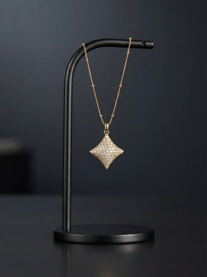 Elegant crystal starburst pendant on chain.