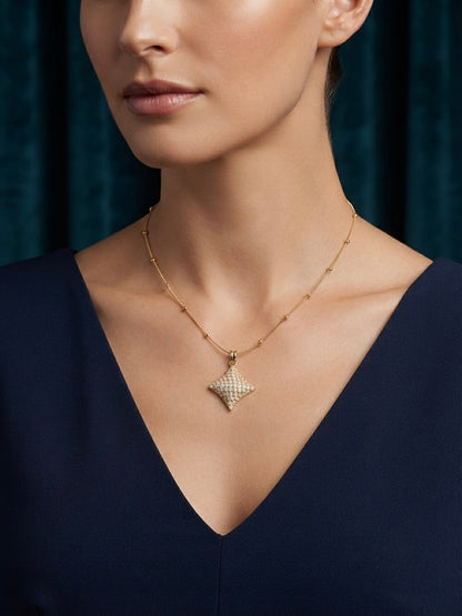 Elegant crystal starburst pendant on chain.