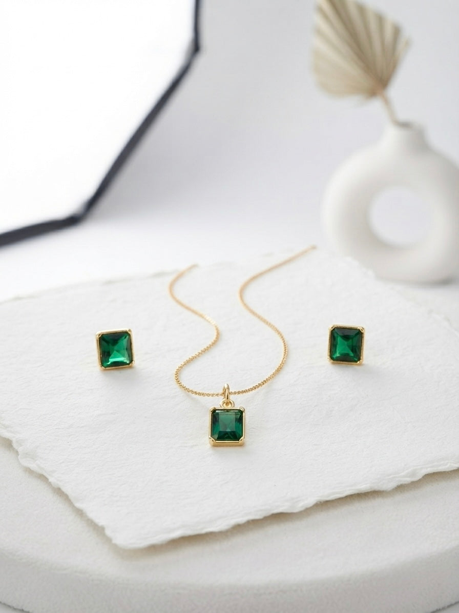 Gold emerald cut green stone necklace set.