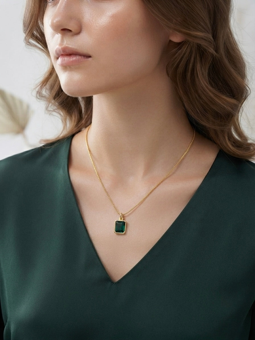 Gold emerald cut green stone necklace set.