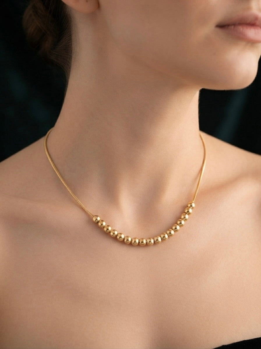 Minimalist gold  chain bead slide necklace.
