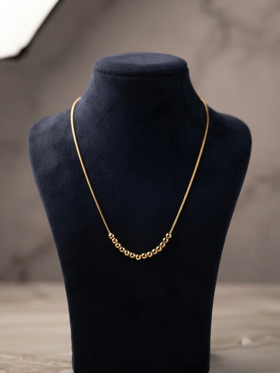 Minimalist gold  chain bead slide necklace.