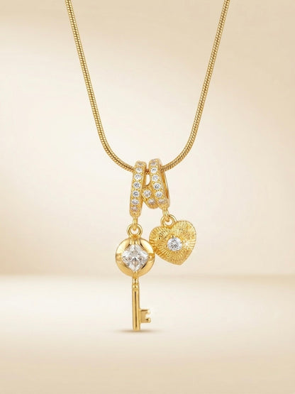 Gold key and heart charm pendant necklace.