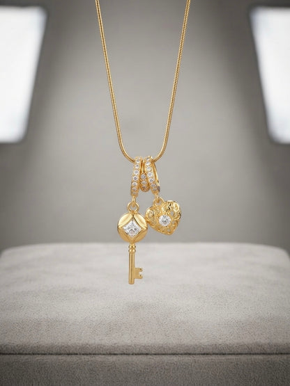 Gold key and heart charm pendant necklace.