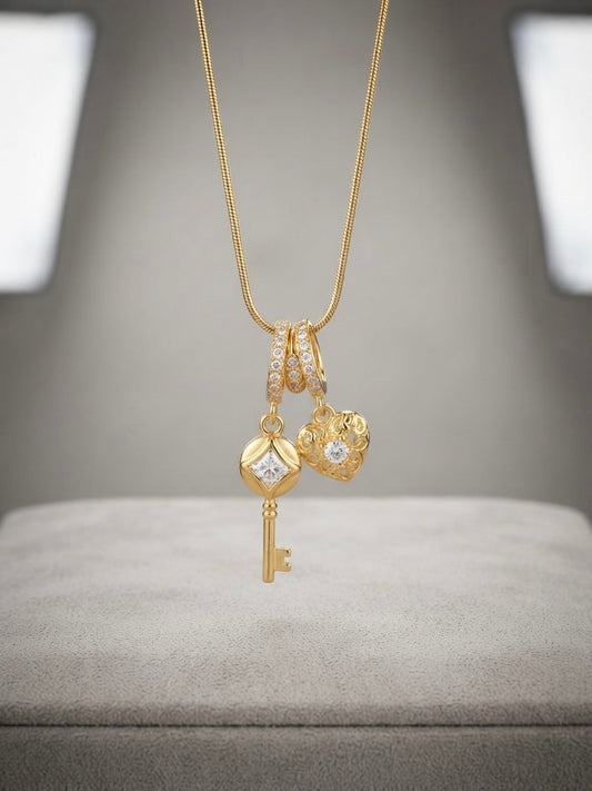 Gold key and heart charm pendant necklace.