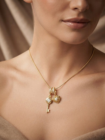 Gold key and heart charm pendant necklace.