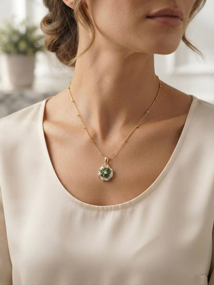 Geometric emerald floral pendant on chain.