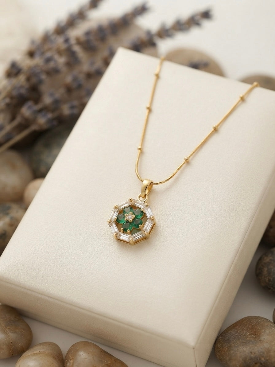 Geometric emerald floral pendant on chain.