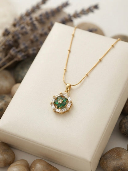 Geometric emerald floral pendant on chain.