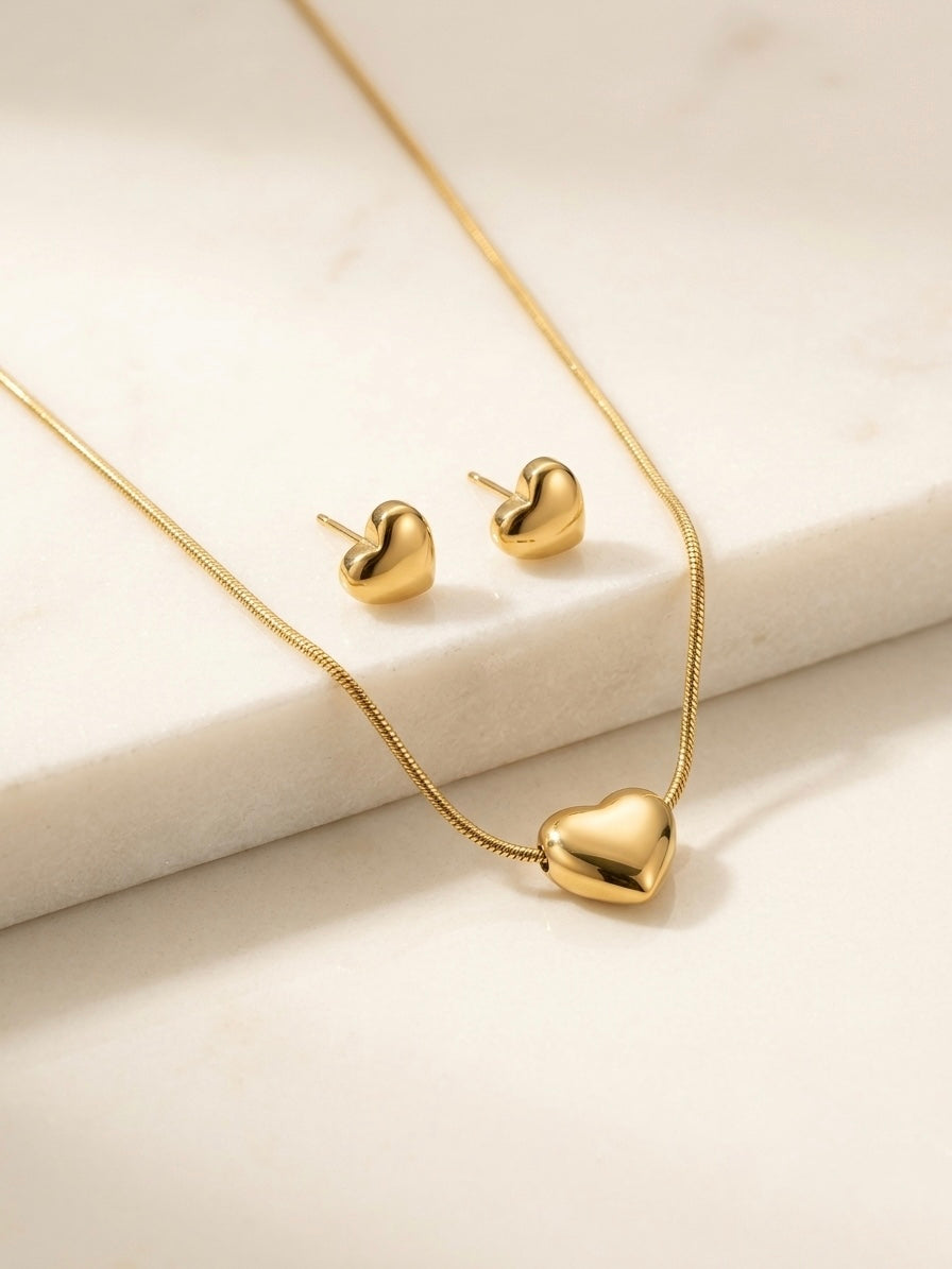 Minimalist gold puffy heart pendant and earrings.