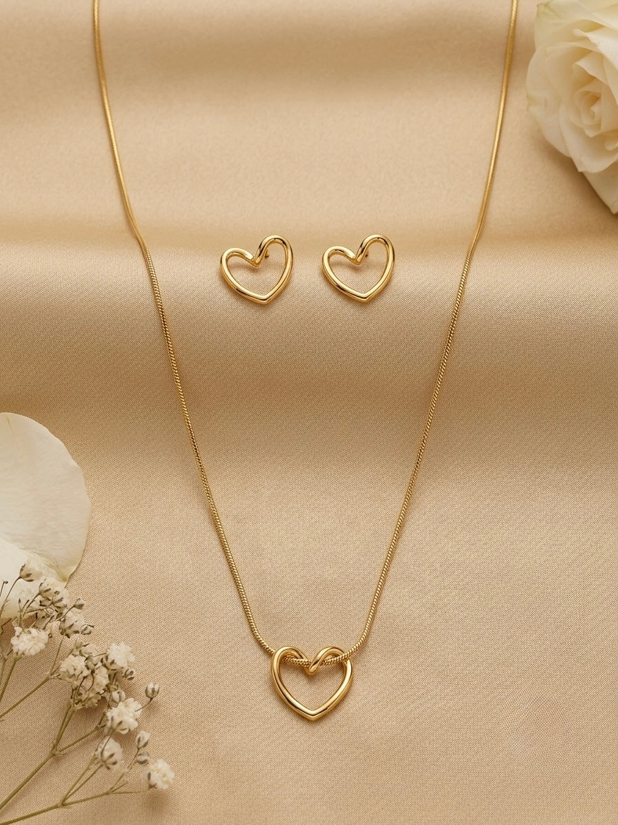 Minimalist hollow gold heart necklace and studs.