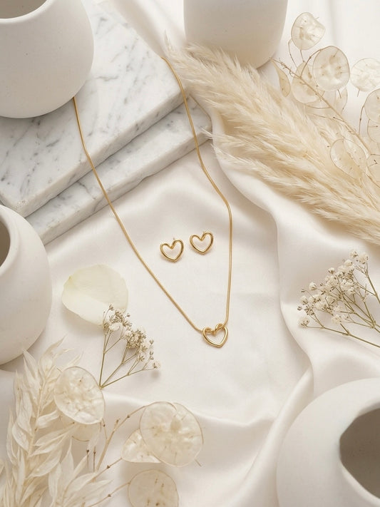 Minimalist hollow gold heart necklace and studs.