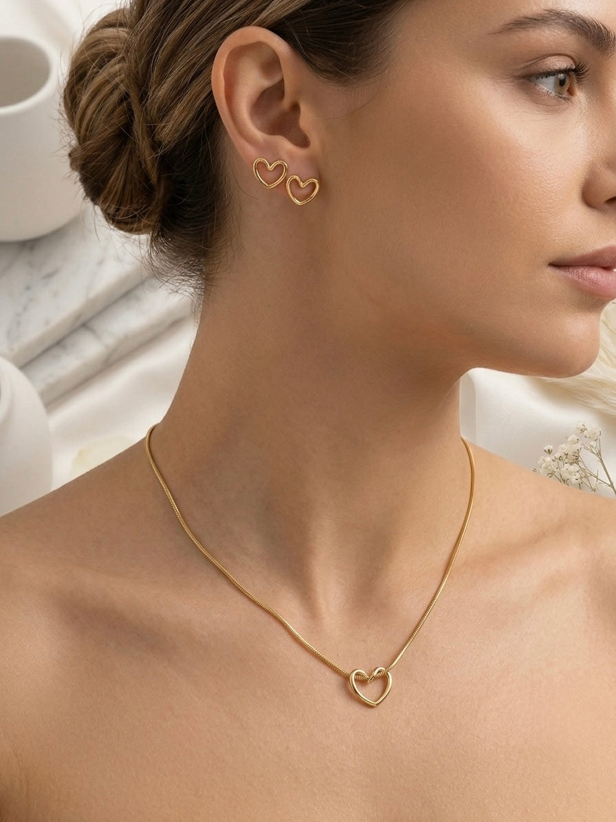 Minimalist hollow gold heart necklace and studs.