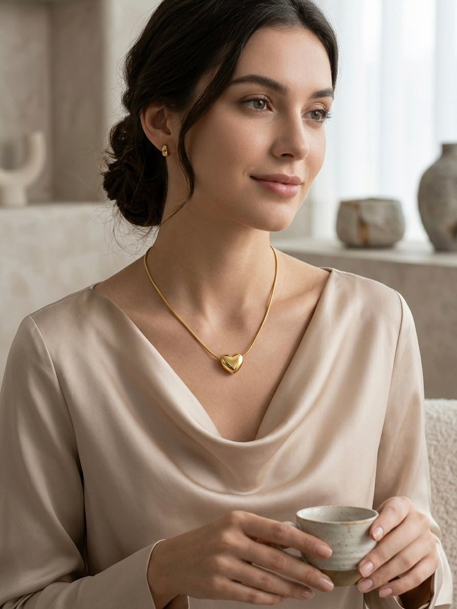 Polished gold puffy heart pendant chain necklace.