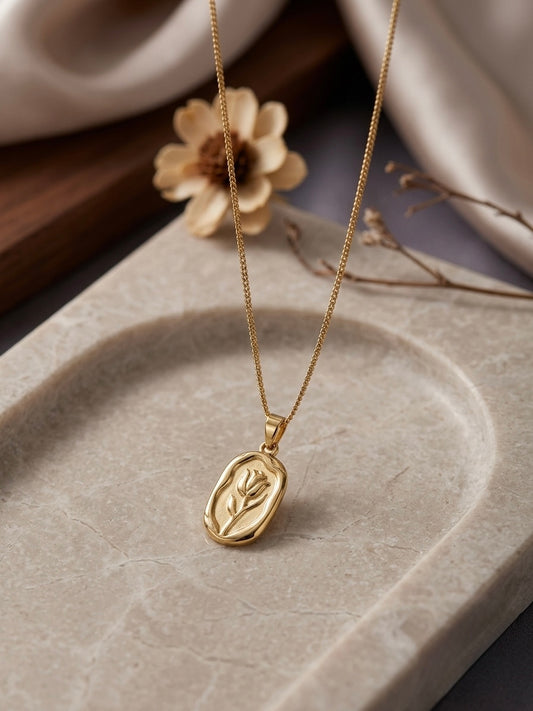 Elegant gold oval rose pendant necklace.