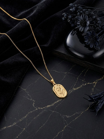 Elegant gold oval rose pendant necklace.