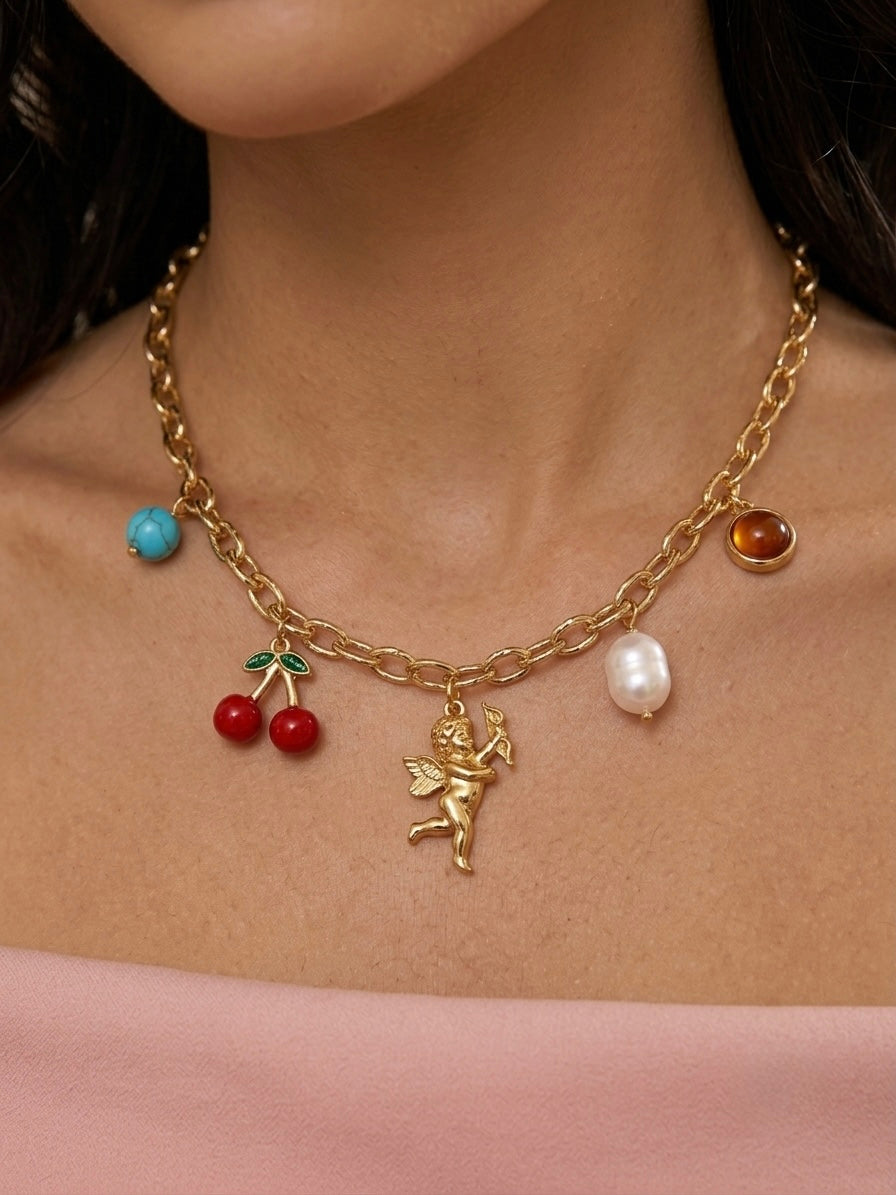 Whimsical multi-charm gold chain necklace.