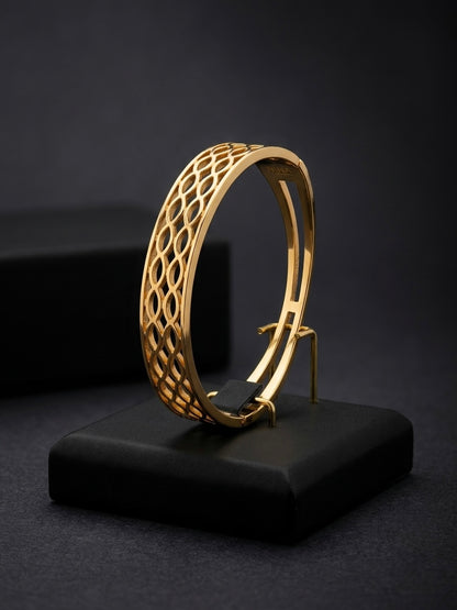 Modern interlocking gold geometric bracelet.