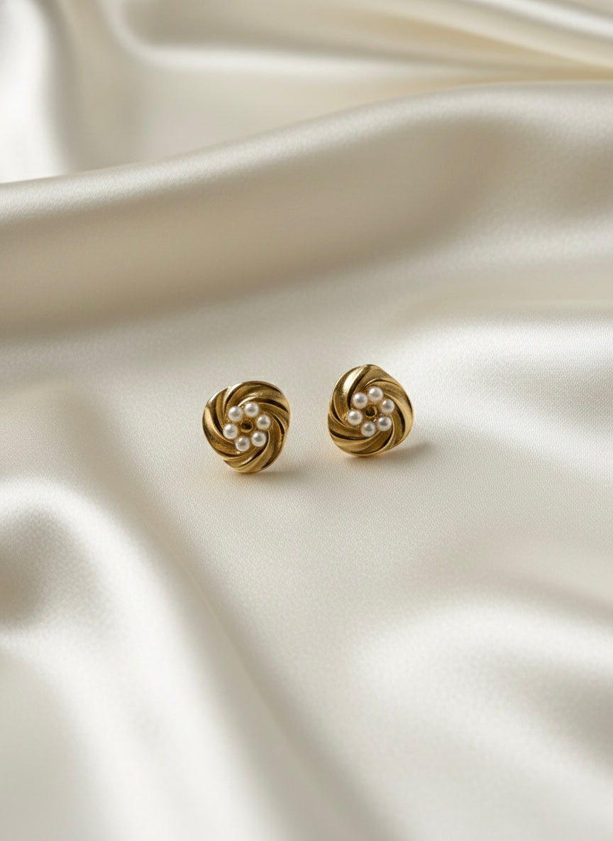 Elegant gold pearl swirl studs.