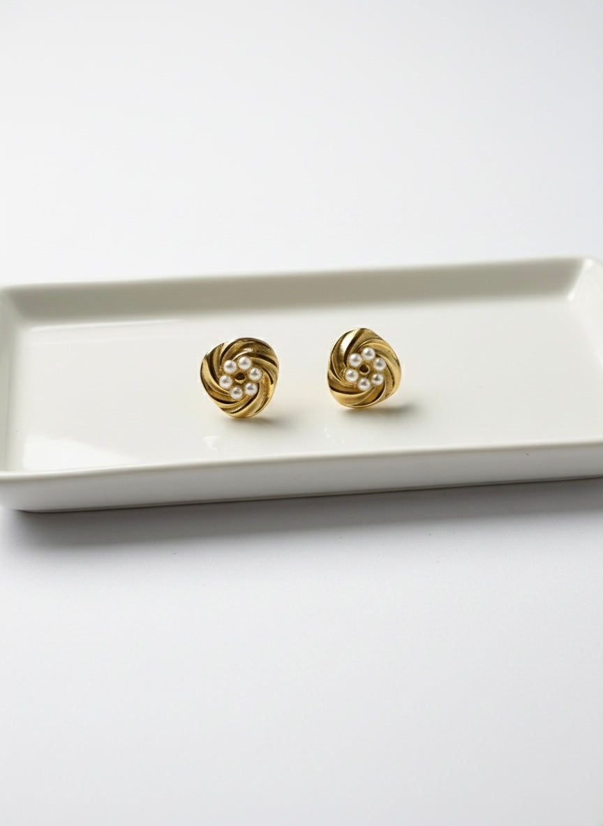 Elegant gold pearl swirl studs.