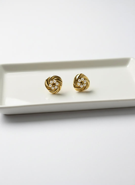 Elegant gold pearl swirl studs.