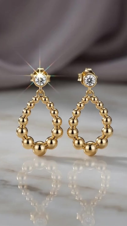Sparkling bezel crystal gold drop studs.