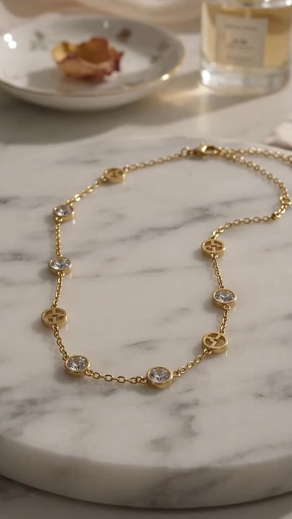 Elegant gold logo charm necklace.