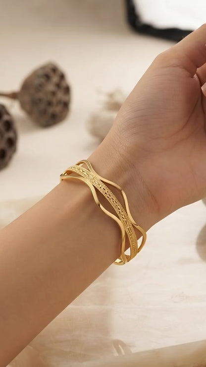 Elegant wavy gold statement bracelet.