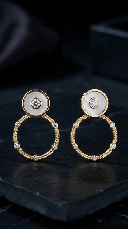 Circular mother-of-pearl and crystal studs.